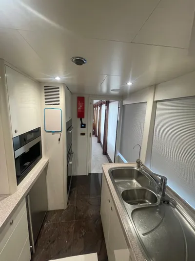 Sarah Sea Yacht Photos Pics Modern kitchen interior of 2004 Kaiserwerft Baron 102 yacht with sleek design and dual sinks.