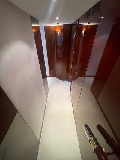 Sarah Sea Yacht Photos Pics Luxurious hallway inside 2004 Kaiserwerft Baron 102 yacht, featuring sleek wood paneling.