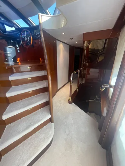 Sarah Sea Yacht Photos Pics Luxurious interior of 2004 Kaiserwerft Baron 102 yacht with elegant wooden staircase.