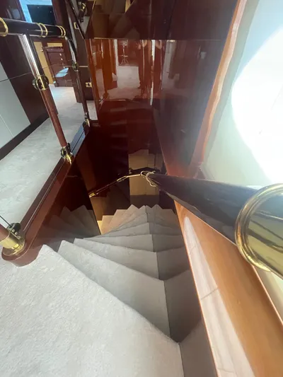 Sarah Sea Yacht Photos Pics Luxurious wooden staircase with brass accents on a 2004 Kaiserwerft Baron 102 yacht.