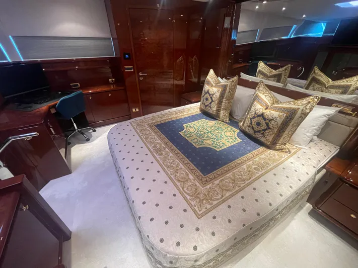 Sarah Sea Yacht Photos Pics Luxurious bedroom interior of 2004 Kaiserwerft Baron 102 yacht with elegant bedding and wood finishes.