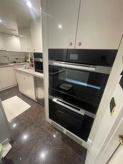 Sarah Sea Yacht Photos Pics Modern kitchen interior on 2004 Kaiserwerft Baron 102 yacht with sleek appliances and glossy flooring.