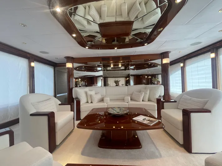 Sarah Sea Yacht Photos Pics Luxurious interior of 2004 Kaiserwerft Baron 102 yacht with elegant seating and wooden accents.