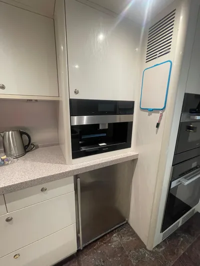 Sarah Sea Yacht Photos Pics Modern kitchen area in 2004 Kaiserwerft Baron 102 yacht with appliances and cabinetry.