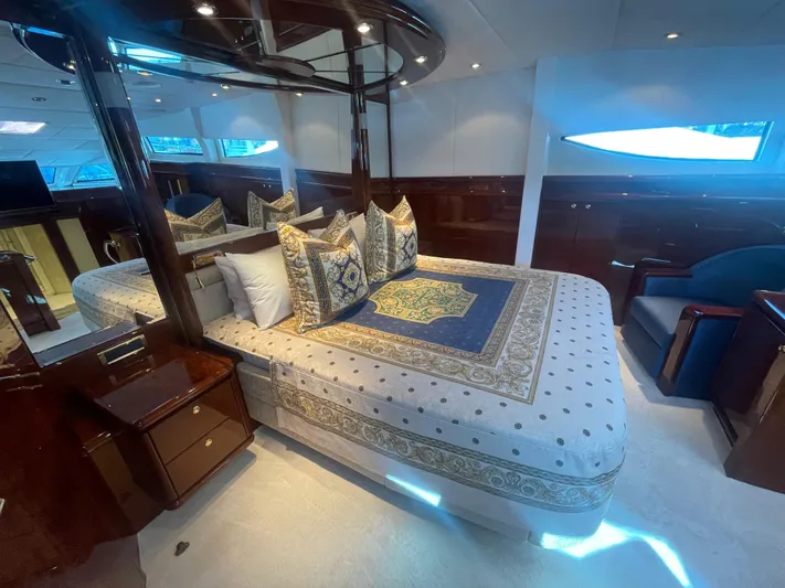 Sarah Sea Yacht Photos Pics Luxurious bedroom interior of 2004 Kaiserwerft Baron 102 yacht with elegant bedding and wood finishes.