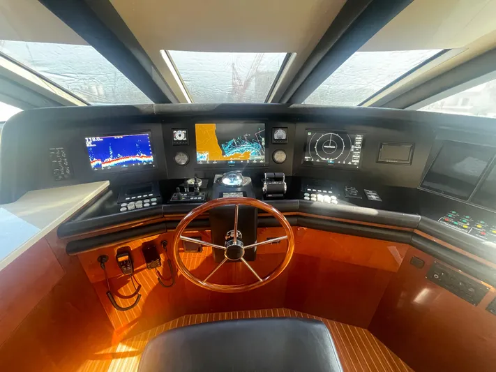 Sarah Sea Yacht Photos Pics Helm of 2004 Kaiserwerft Baron 102 yacht with navigation screens and wooden steering wheel.