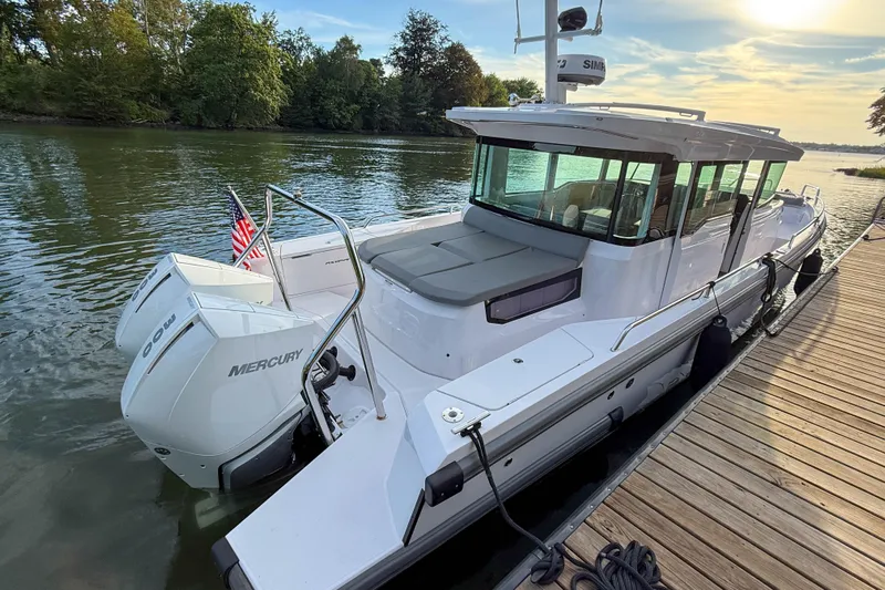 Raven Yacht Photos Pics 2021 Axopar 37 XC CROSS CABIN boat docked, featuring twin Mercury engines.