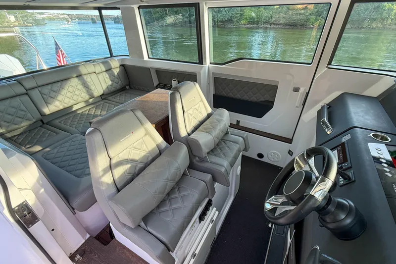 Raven Yacht Photos Pics 2021 Axopar 37 XC CROSS CABIN interior with luxurious seating and modern helm.