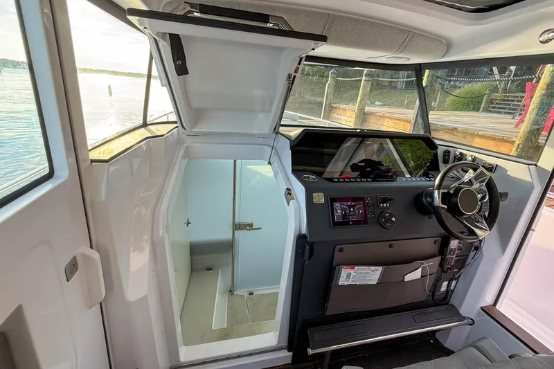 Raven Yacht Photos Pics 2021 Axopar 37 XC CROSS CABIN interior with helm and cabin entrance.