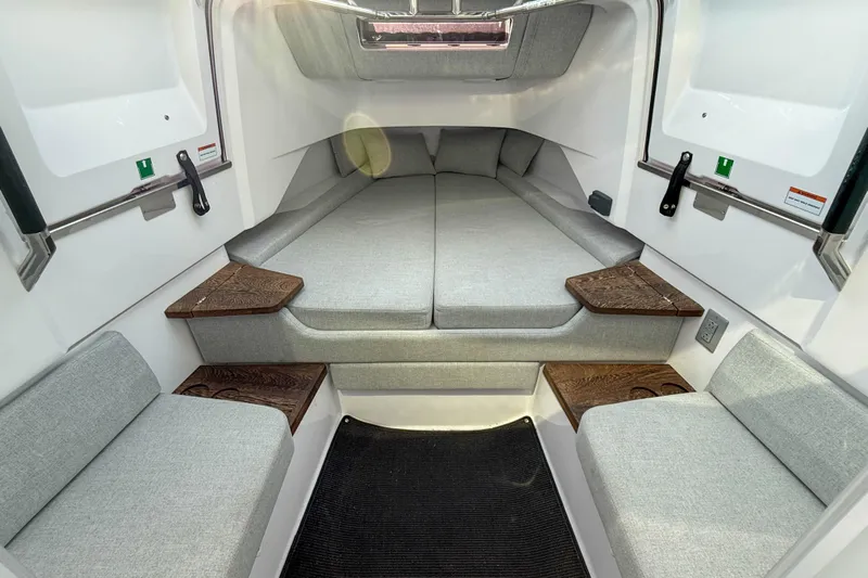 Raven Yacht Photos Pics Interior cabin of 2021 Axopar 37 XC CROSS CABIN with gray seating and wooden accents.