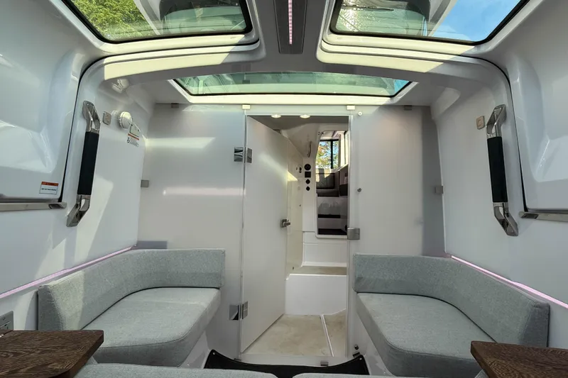 Raven Yacht Photos Pics Interior of 2021 Axopar 37 XC CROSS CABIN with skylights and modern seating.
