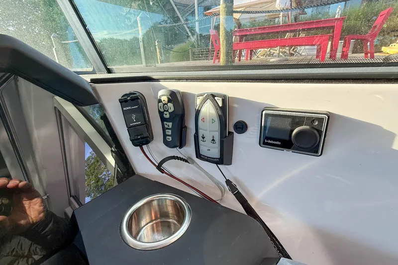 Raven Yacht Photos Pics Control panel of 2021 Axopar 37 XC CROSS CABIN with electronic devices and cup holder.