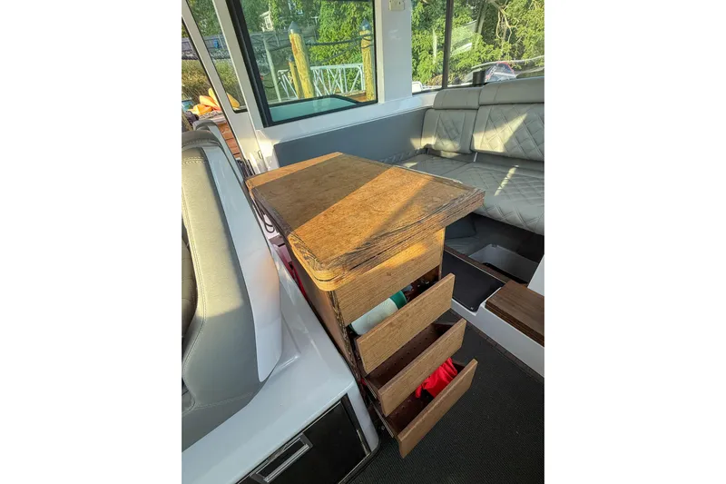 Raven Yacht Photos Pics Interior of 2021 Axopar 37 XC CROSS CABIN with wooden storage drawers and seating.