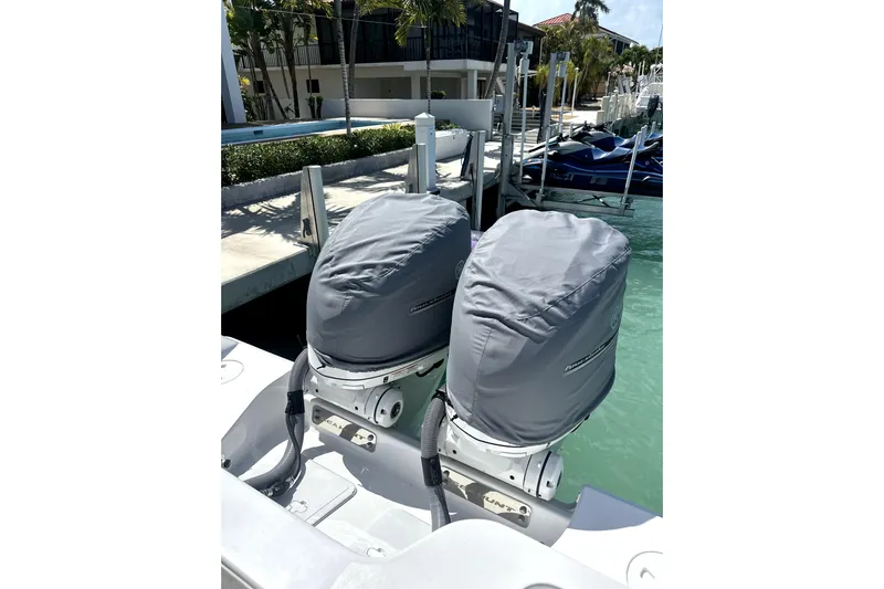  Yacht Photos Pics 2025 Sea Hunt Gamefish 28 boat with covered twin outboard motors at a marina.