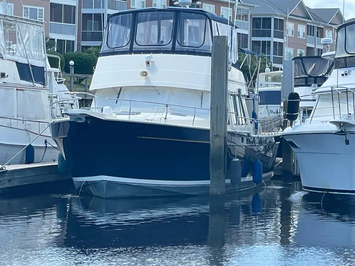 Nowhere Fast Yacht Photos Pics 2005 Mainship 430 Aft Cabin 3SR Trawler docked at marina.