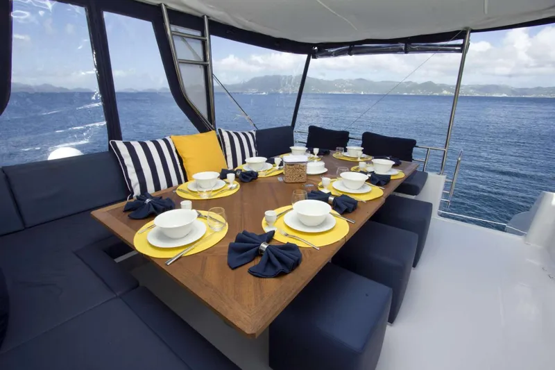 Neverland Yacht Photos Pics Luxurious dining setup on 2018 Fountaine Pajot Catamaran 67 with ocean view.