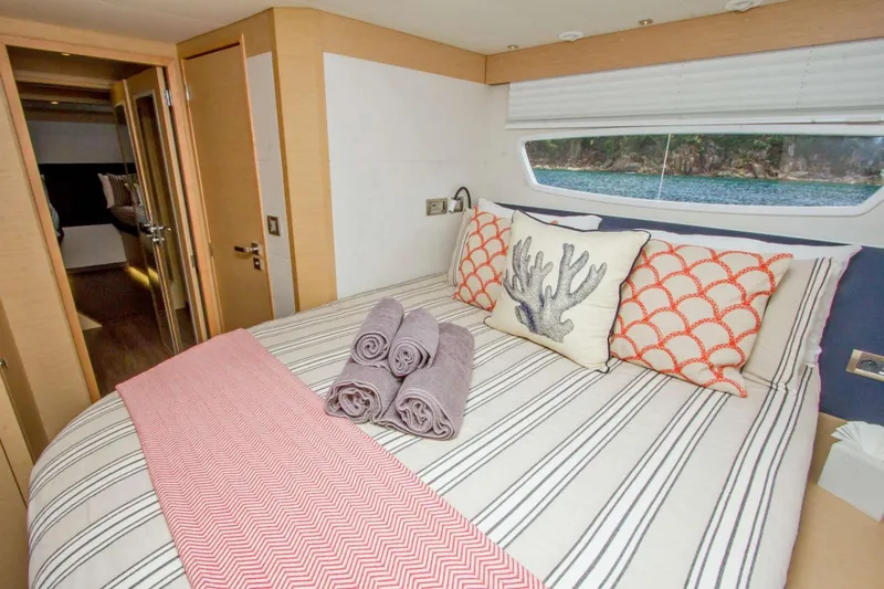 Neverland Yacht Photos Pics Luxurious bedroom interior of 2018 Fountaine Pajot Catamaran 67 with stylish decor and ocean view.