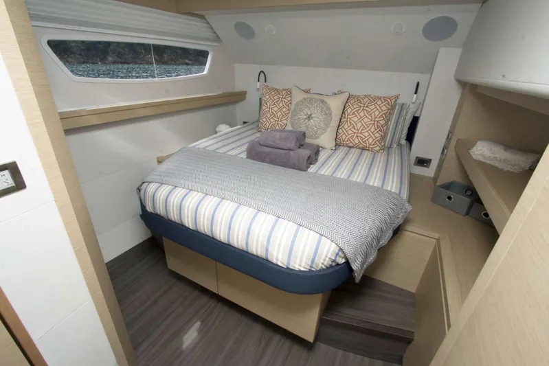 Neverland Yacht Photos Pics Luxurious cabin interior of 2018 Fountaine Pajot Catamaran 67 with cozy bedding.