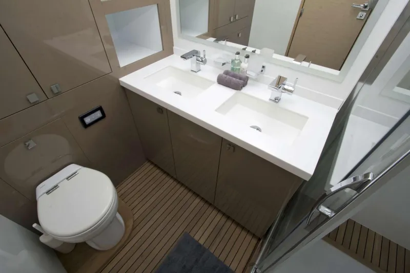 Neverland Yacht Photos Pics Luxurious bathroom in 2018 Fountaine Pajot Catamaran 67 with dual sinks and modern fixtures.