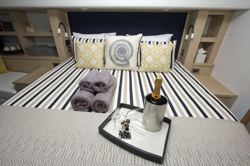 Neverland Yacht Photos Pics Luxurious bedroom in 2018 Fountaine Pajot Catamaran 67 with champagne and elegant decor.