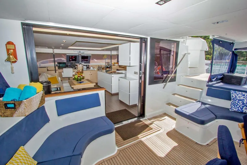 Neverland Yacht Photos Pics Luxurious interior of 2018 Fountaine Pajot Catamaran 67 with modern seating and kitchen.