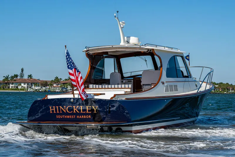  Yacht Photos Pics 2025 Hinckley Picnic Boat 40 cruising on water, displaying American flag.