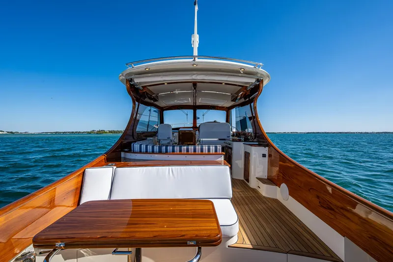  Yacht Photos Pics 2025 Hinckley Picnic Boat 40 on open water, featuring elegant wood and white seating.
