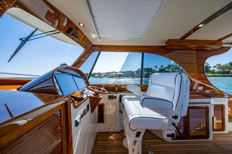  Yacht Photos Pics 2025 Hinckley Picnic Boat 40 interior with elegant wood finish and modern helm.