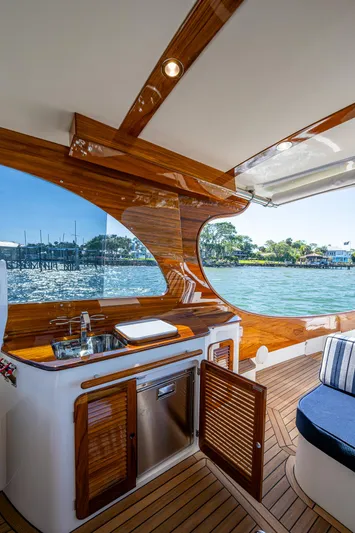 Yacht Photos Pics 2025 Hinckley Picnic Boat 40 interior with elegant wood finish and waterfront view.