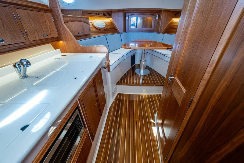  Yacht Photos Pics Luxurious interior of 2025 Hinckley Picnic Boat 40 with wood finishes and modern amenities.