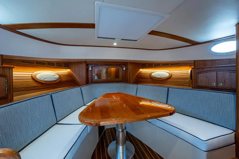  Yacht Photos Pics Interior of 2025 Hinckley Picnic Boat 40, featuring elegant wood finishes and cozy seating.