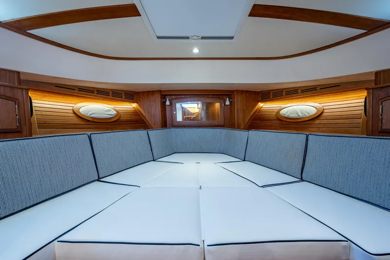  Yacht Photos Pics 2025 Hinckley Picnic Boat 40 interior with elegant seating and wooden accents.