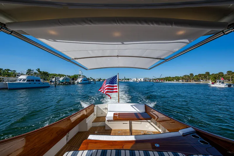  Yacht Photos Pics 2025 Hinckley Picnic Boat 40 cruising on a sunny day, American flag waving.