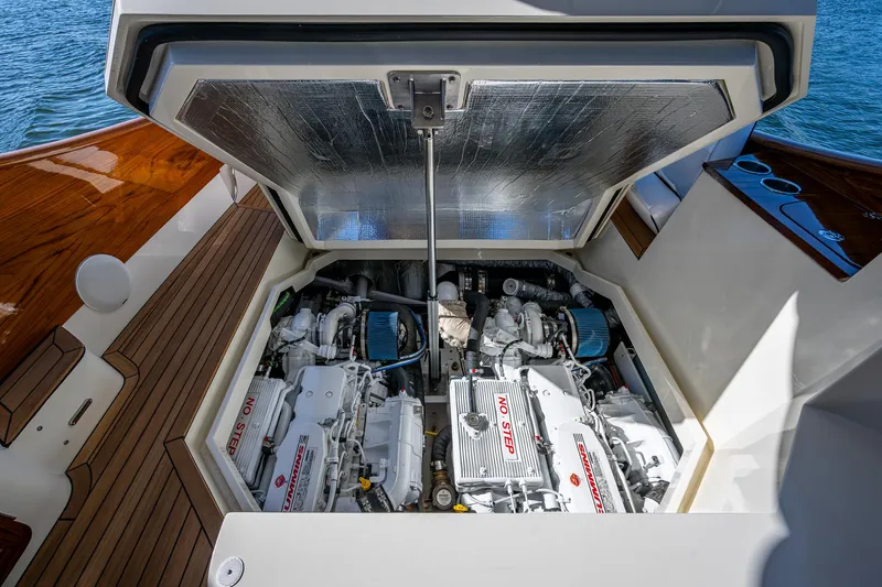  Yacht Photos Pics 2025 Hinckley Picnic Boat 40 engine compartment with twin engines, open hatch, and teak deck.