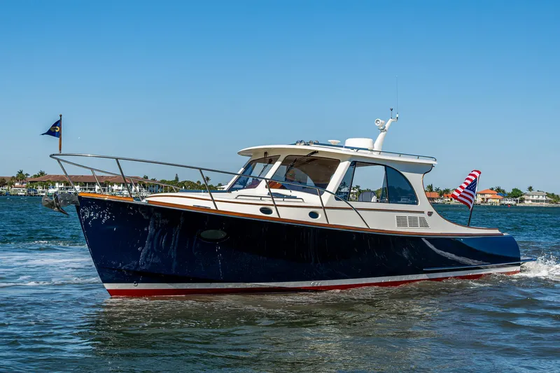  Yacht Photos Pics 2025 Hinckley Picnic Boat 40 cruising on a sunny day, displaying sleek design and elegance.