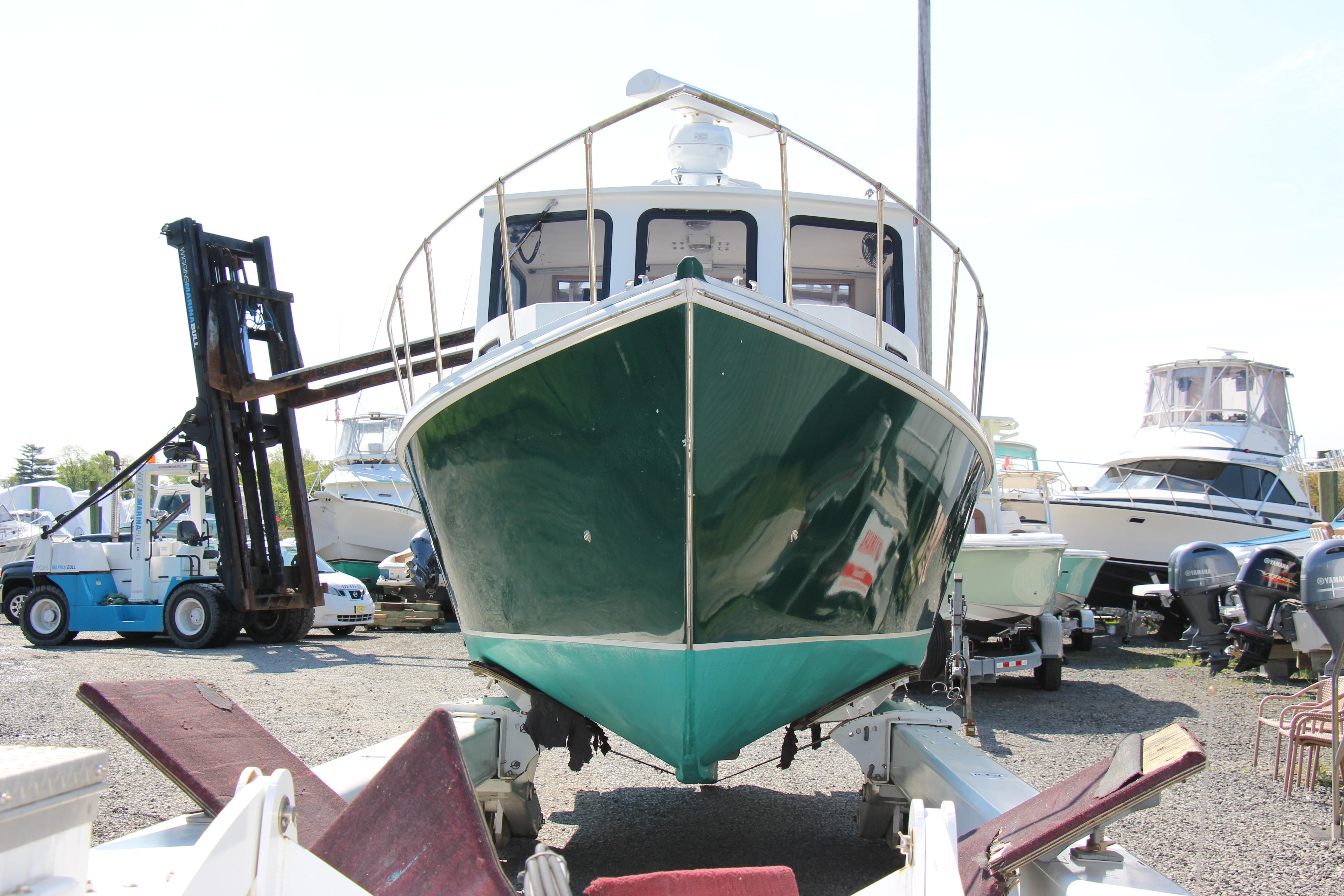 2009 Custom Alley Boats 28 Downeast on trailer in boatyard.