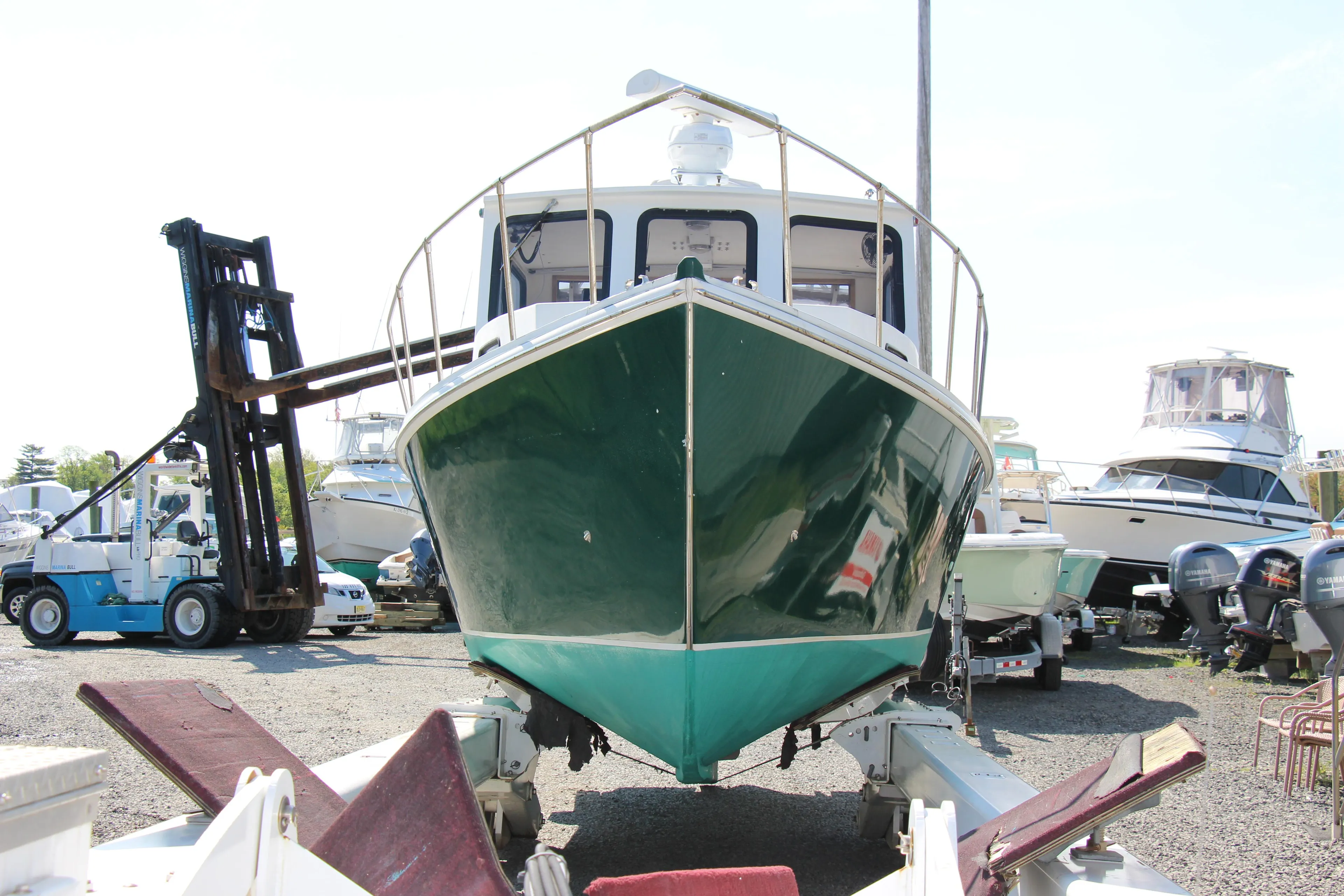 2009 Custom Alley Boats 28 Downeast on trailer in boatyard.