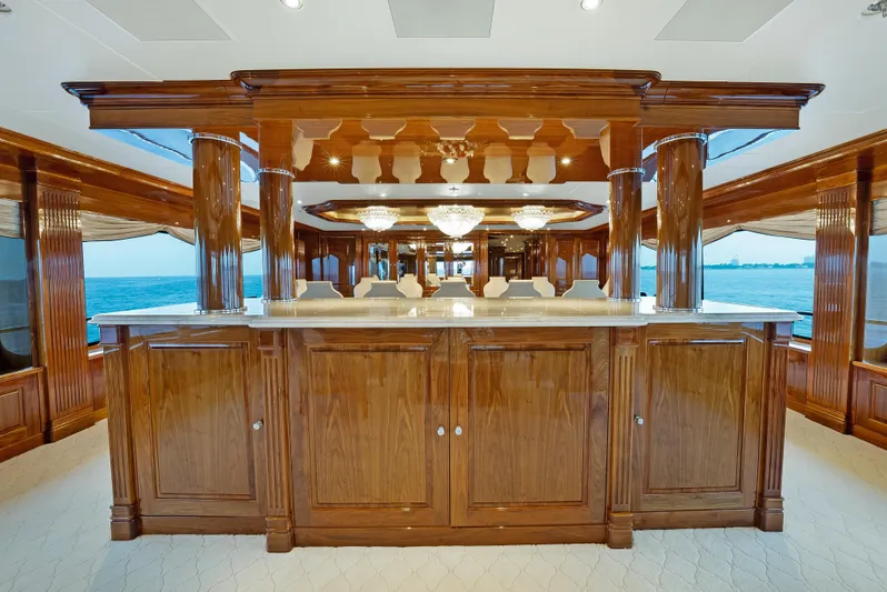 Silver Lining Yacht Photos Pics Luxurious interior of 2016 Christensen Tri-Deck yacht with elegant wooden bar and ocean view.