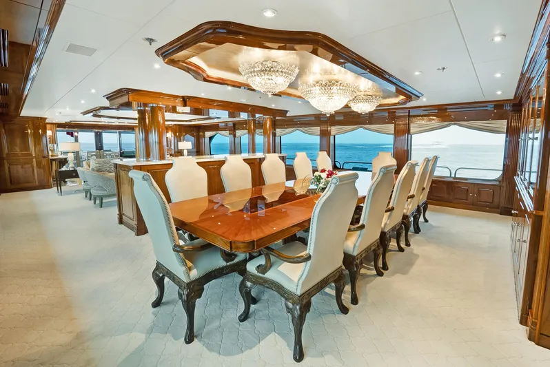 Silver Lining Yacht Photos Pics Luxurious dining area on 2016 Christensen Tri-Deck yacht with elegant chandeliers and ocean view.