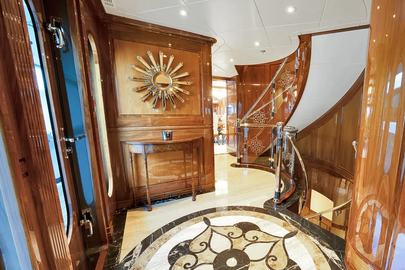 Silver Lining Yacht Photos Pics Luxurious interior of 2016 Christensen Tri-Deck yacht with elegant wood paneling and spiral staircase.