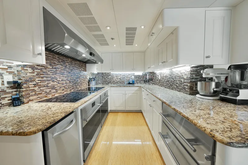 Silver Lining Yacht Photos Pics Luxurious kitchen in 2016 Christensen Tri-Deck yacht with granite countertops and modern appliances.