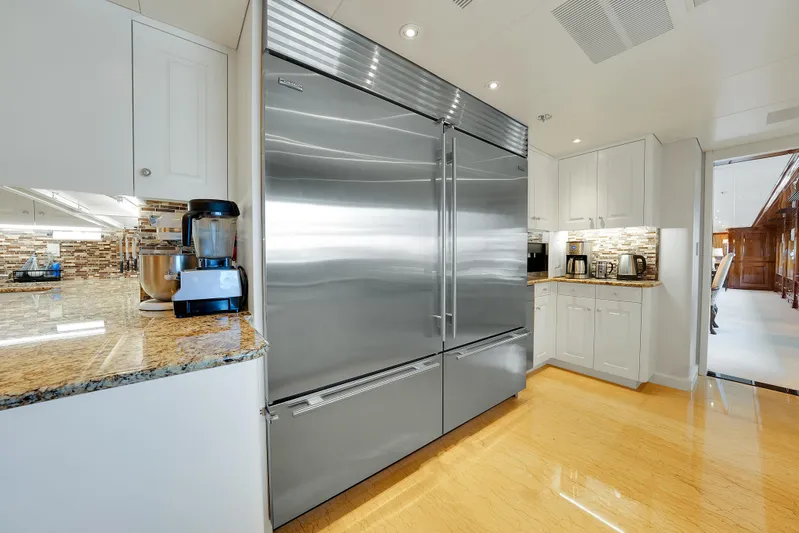 Silver Lining Yacht Photos Pics Luxurious kitchen on 2016 Christensen Tri-Deck yacht with stainless steel appliances and granite countertops.