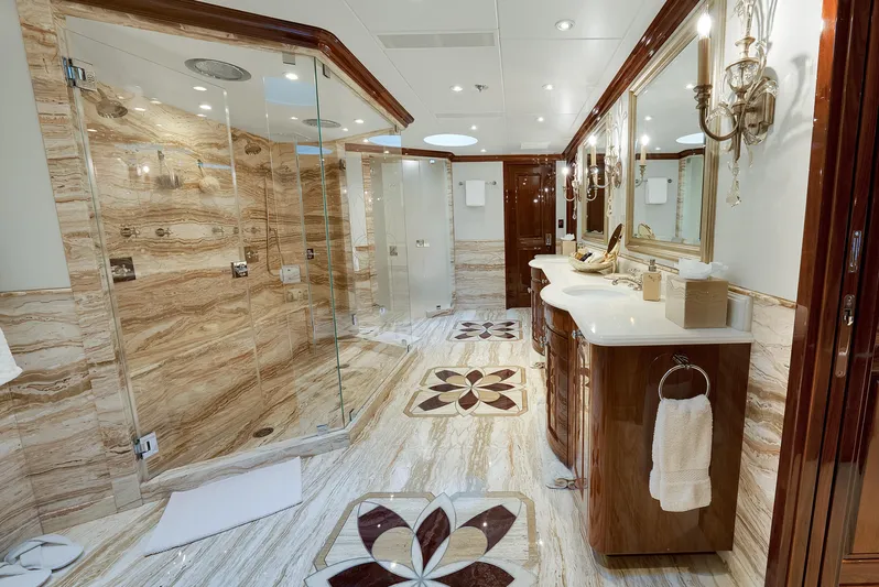 Silver Lining Yacht Photos Pics Luxurious bathroom on 2016 Christensen Tri-Deck yacht with elegant marble and glass shower.