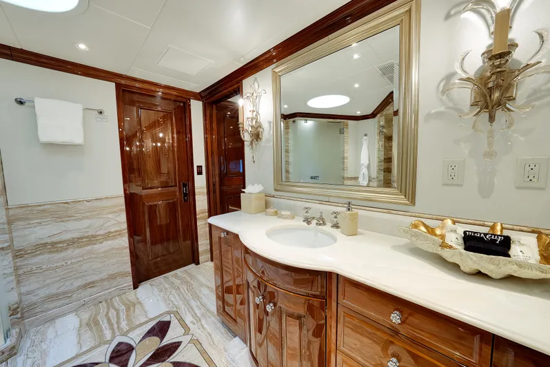 Silver Lining Yacht Photos Pics Luxurious bathroom on 2016 Christensen Tri-Deck yacht with elegant wood finishes and marble accents.