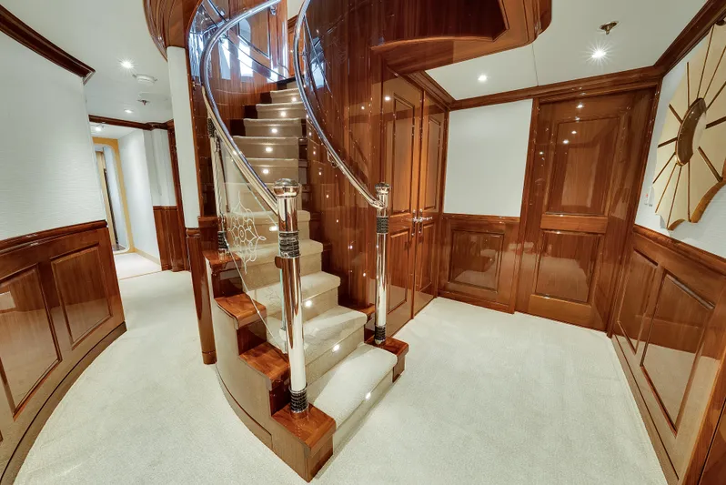 Silver Lining Yacht Photos Pics Luxurious interior of 2016 Christensen Tri-Deck yacht with elegant wooden staircase and modern design.