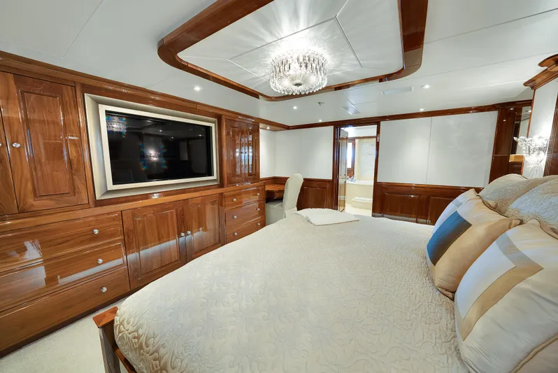 Silver Lining Yacht Photos Pics Luxurious bedroom on 2016 Christensen Tri-Deck yacht with elegant wood finishes and modern amenities.