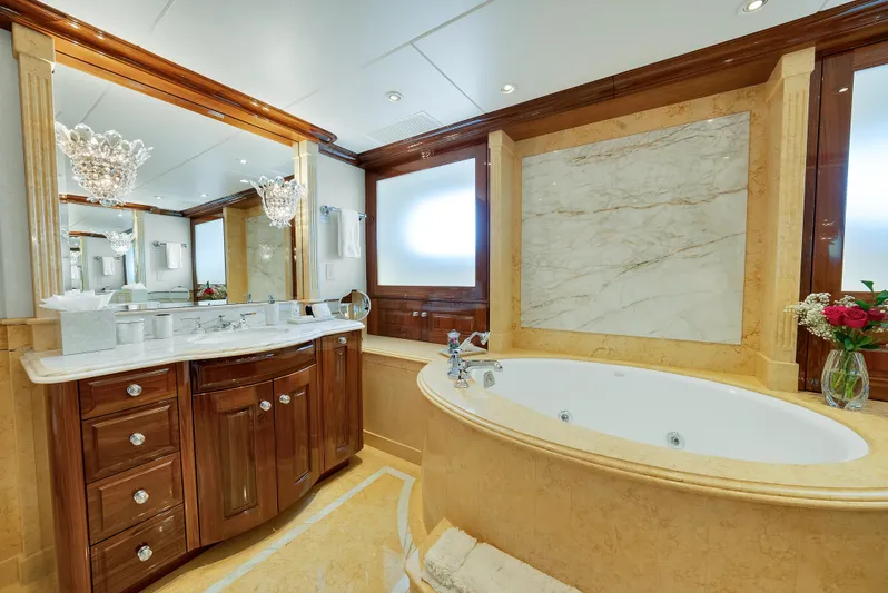 Silver Lining Yacht Photos Pics Luxurious bathroom on 2016 Christensen Tri-Deck yacht with elegant wood and marble finishes.