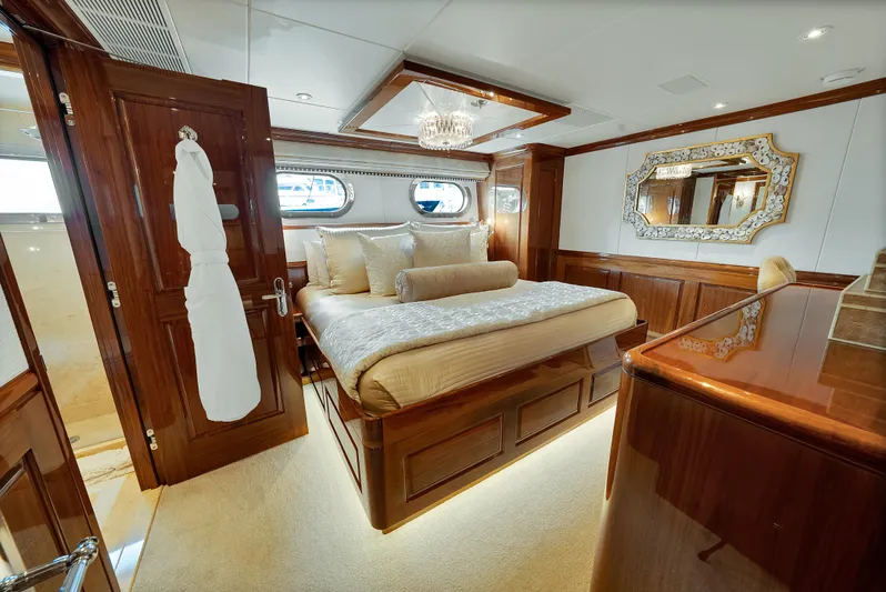 Silver Lining Yacht Photos Pics Luxurious bedroom on 2016 Christensen Tri-Deck yacht with elegant wood finishes and plush bedding.