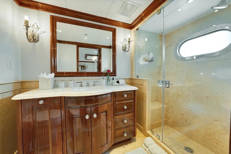 Silver Lining Yacht Photos Pics Luxurious bathroom on 2016 Christensen Tri-Deck yacht with elegant wood cabinetry and glass shower.
