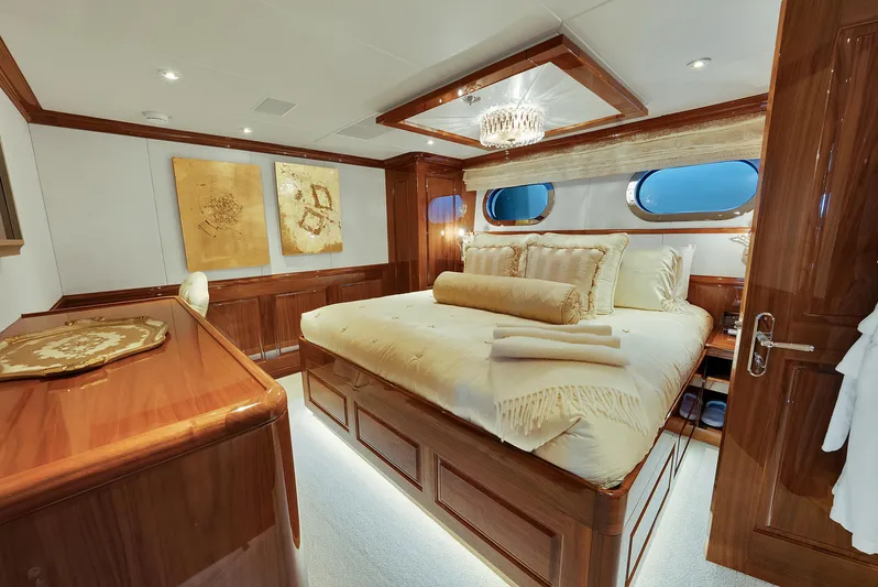 Silver Lining Yacht Photos Pics Luxurious bedroom interior on 2016 Christensen Tri-Deck yacht with elegant wood finishes.